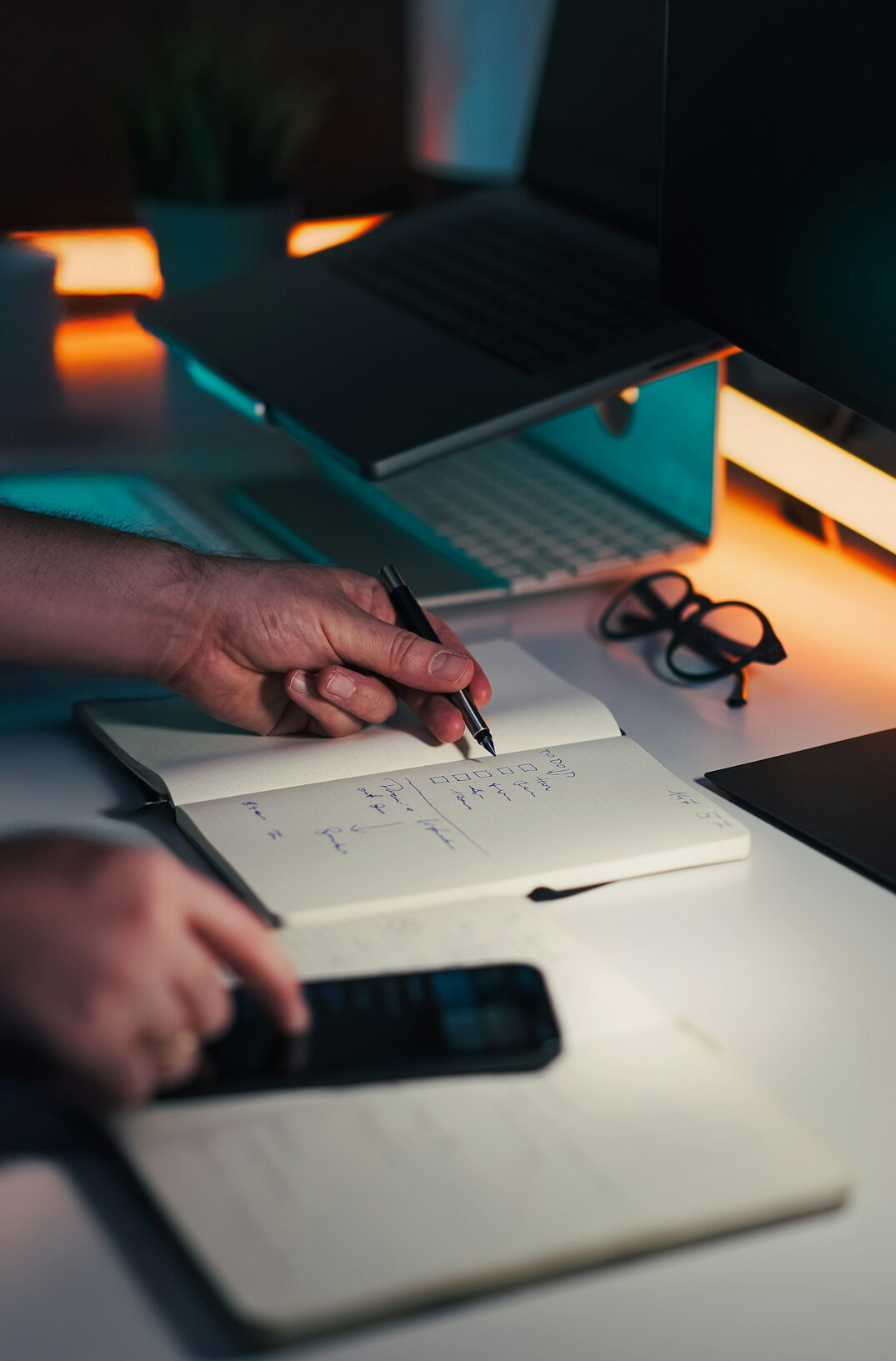 person writing in journal at night