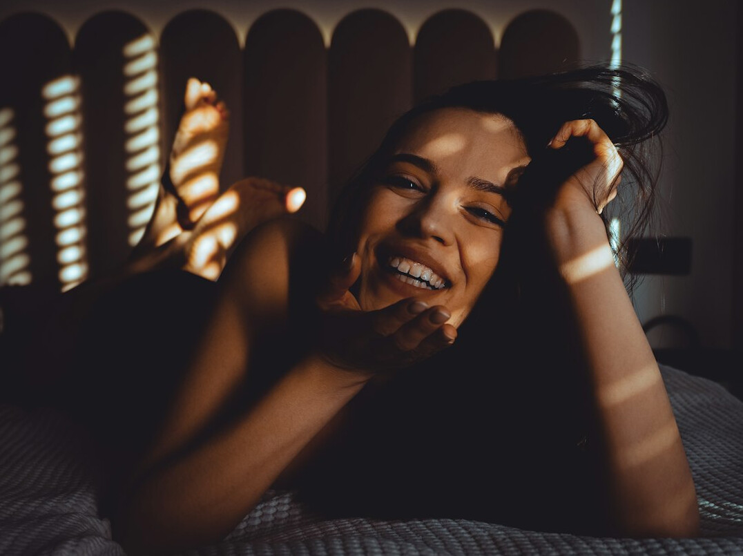person waking up happy in bed